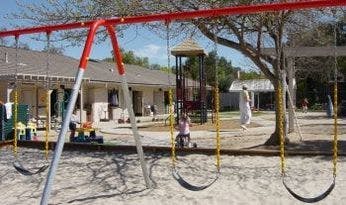 Child on a swing set at a playground