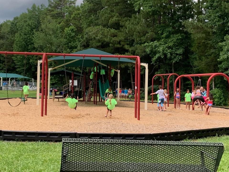 Children playing on a playground with swings and slides