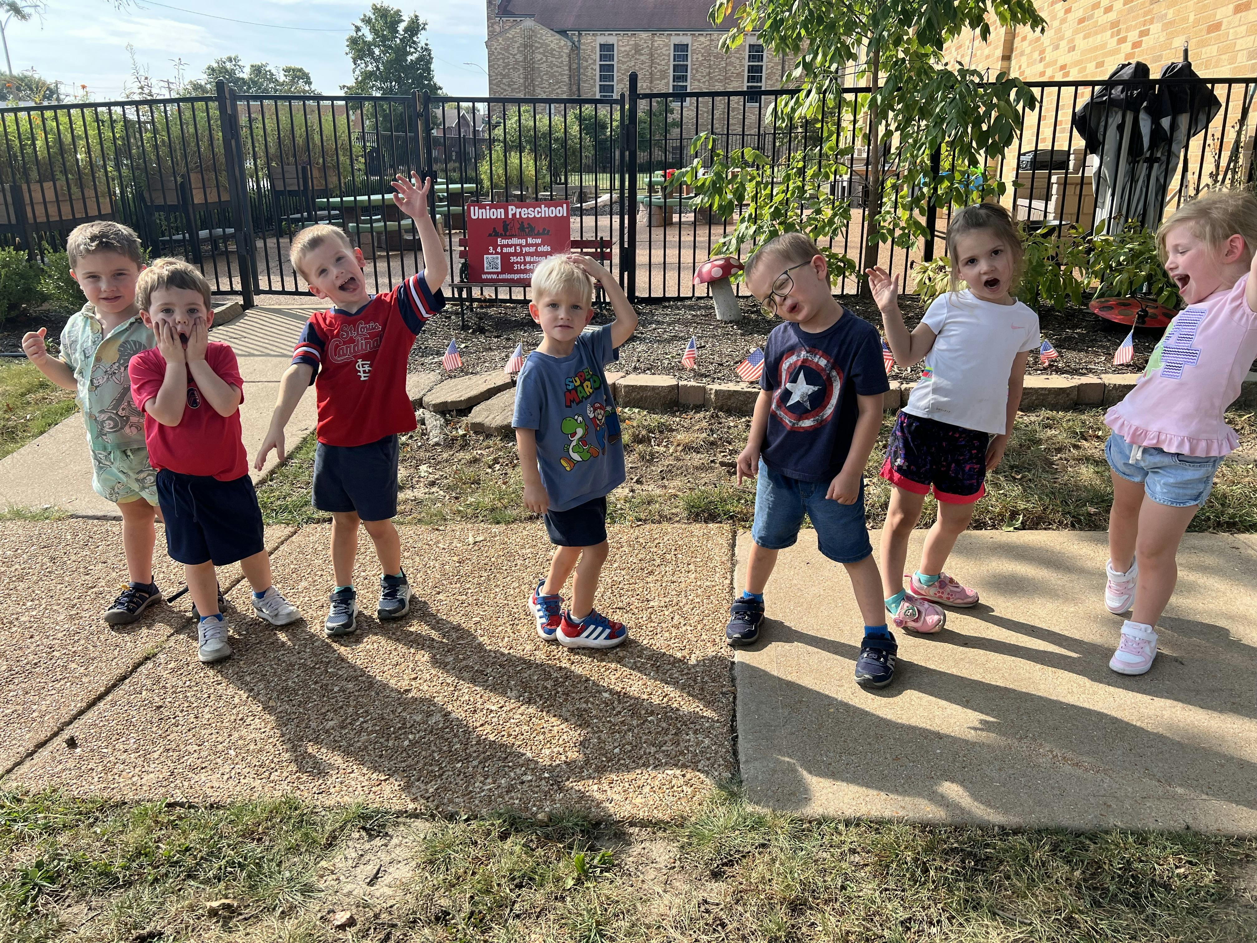 Group of children standing in front of a Union Preschool sign