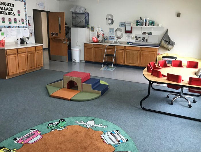 Classroom with play equipment, tables, and counters