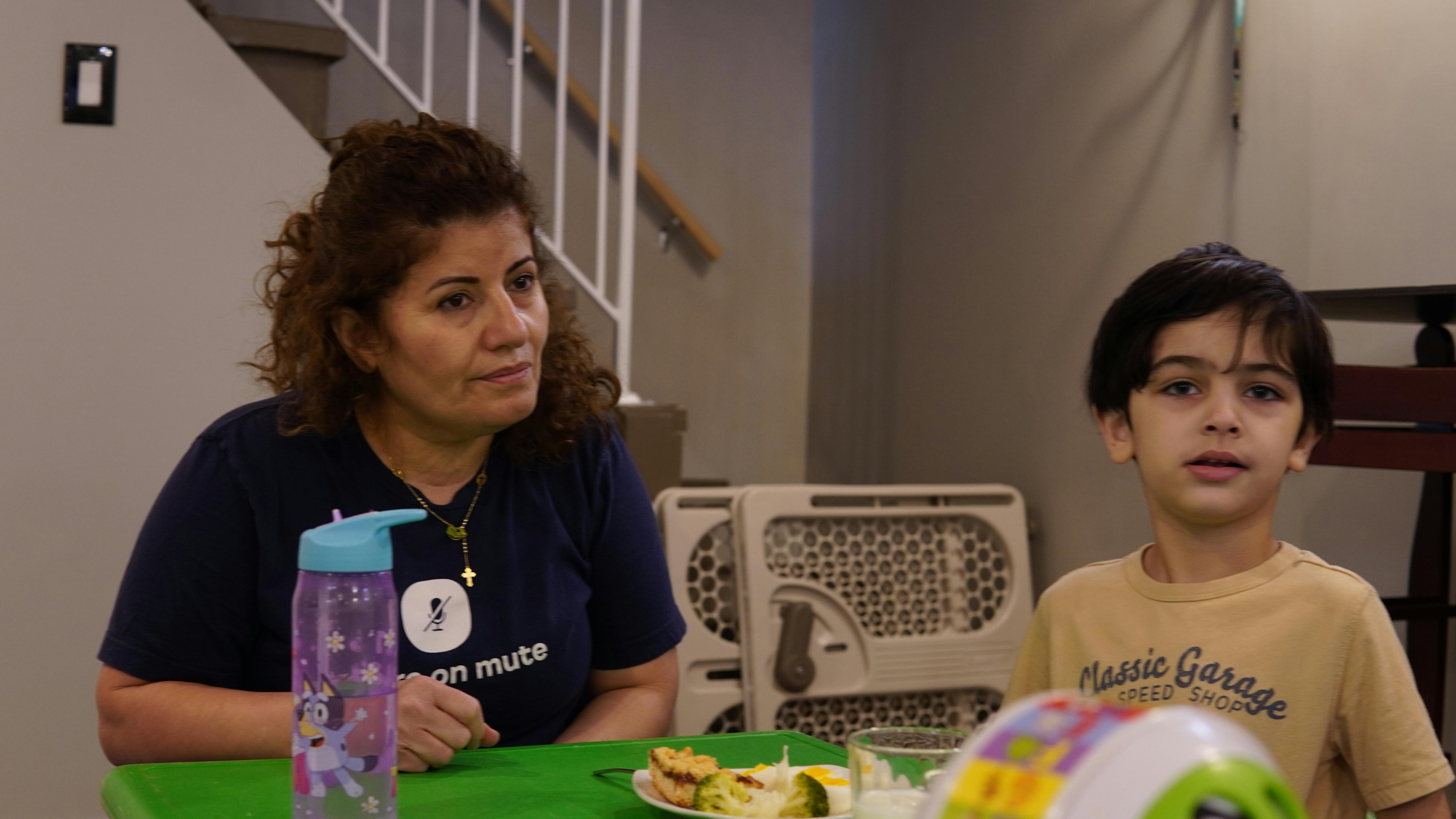 Person and child sitting at a table