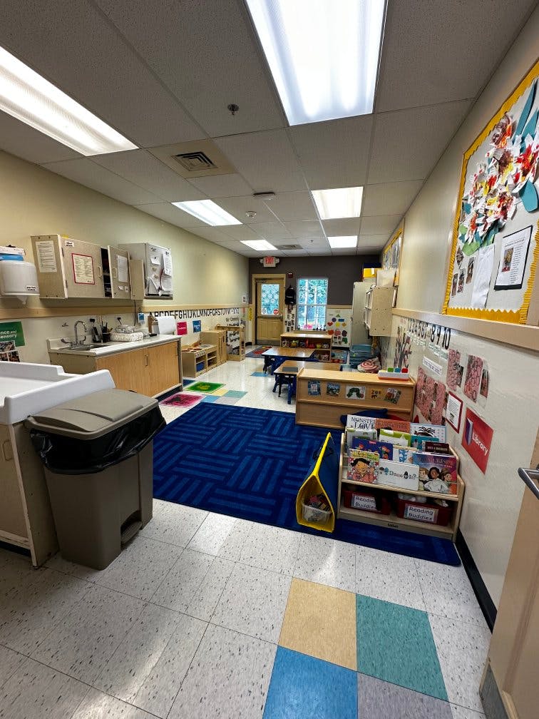 Classroom with child-sized furniture and a book display