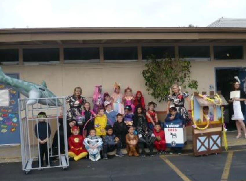 Group of children and adults in costumes outdoors