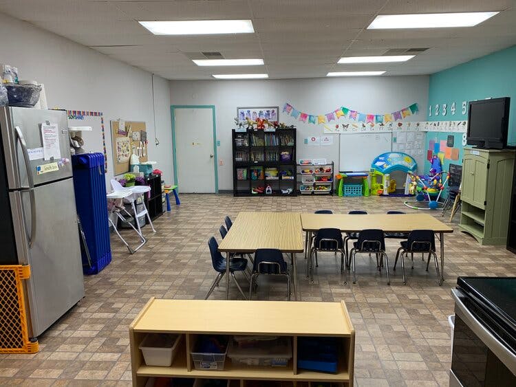 Classroom with tables, chairs, and play area