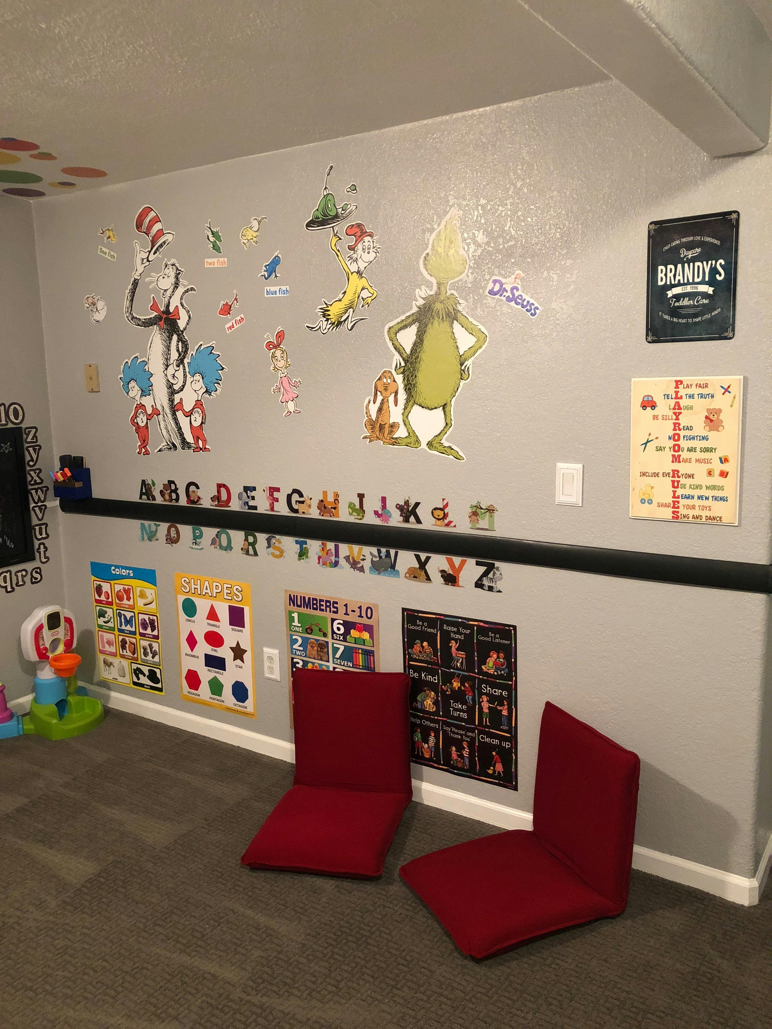 Wall decorated with Dr. Seuss characters and educational posters