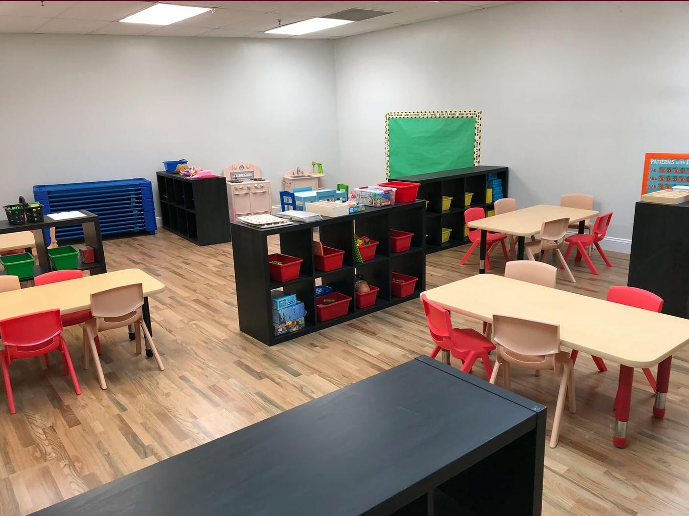 Empty classroom with small tables and chairs
