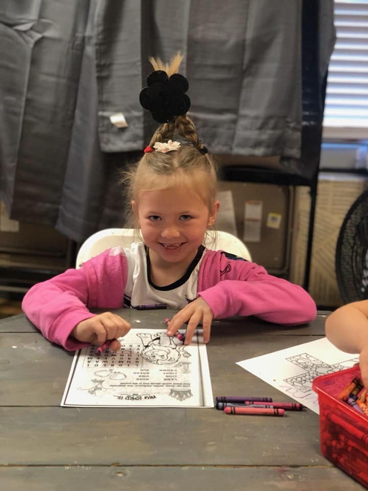 Child coloring at a table