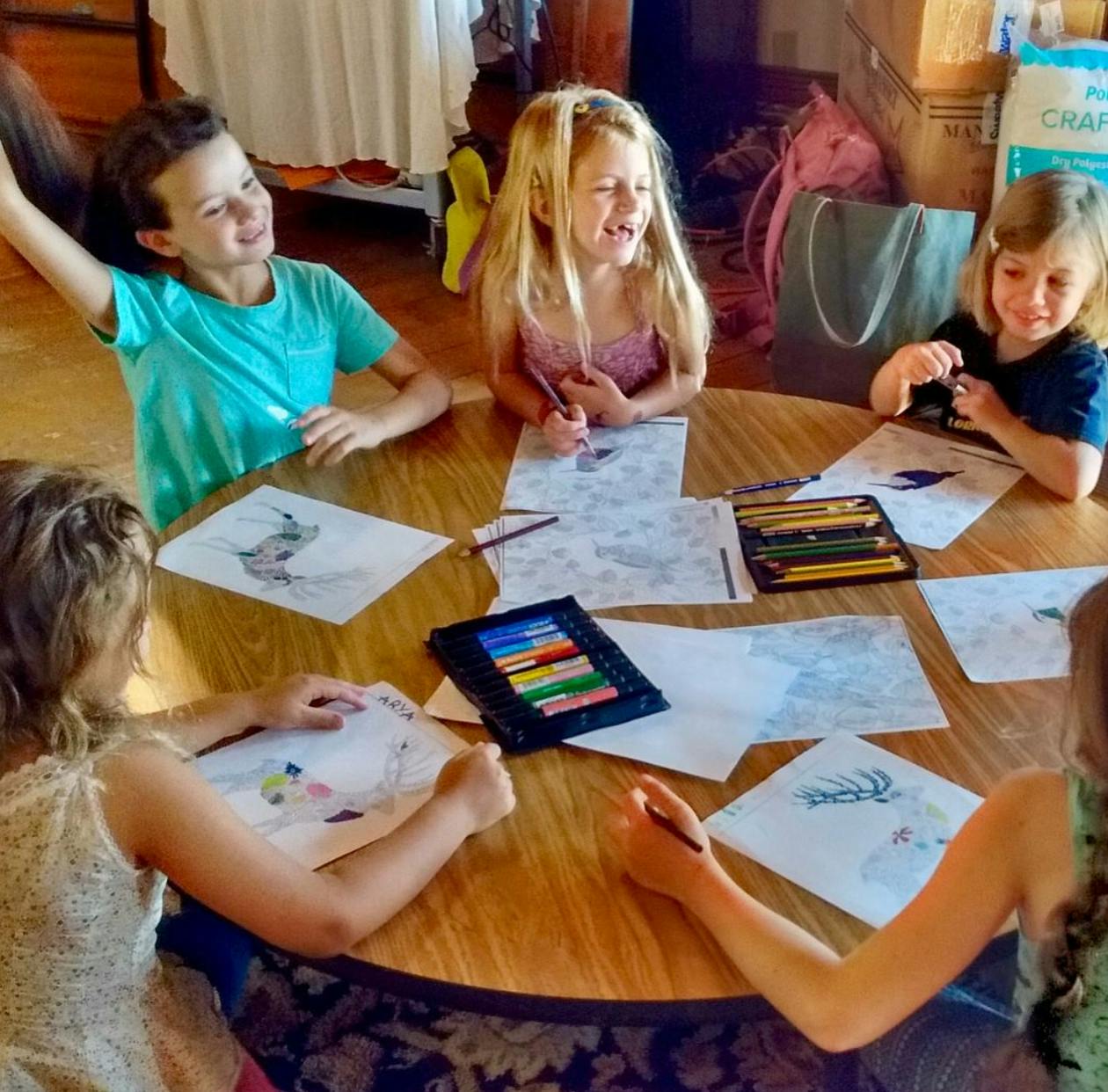 Children drawing and coloring at a round table