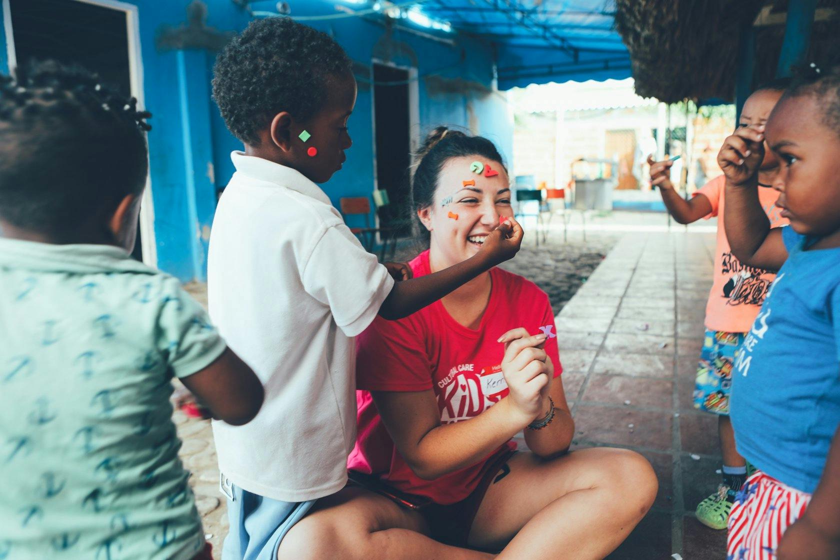 Child painting a person's face