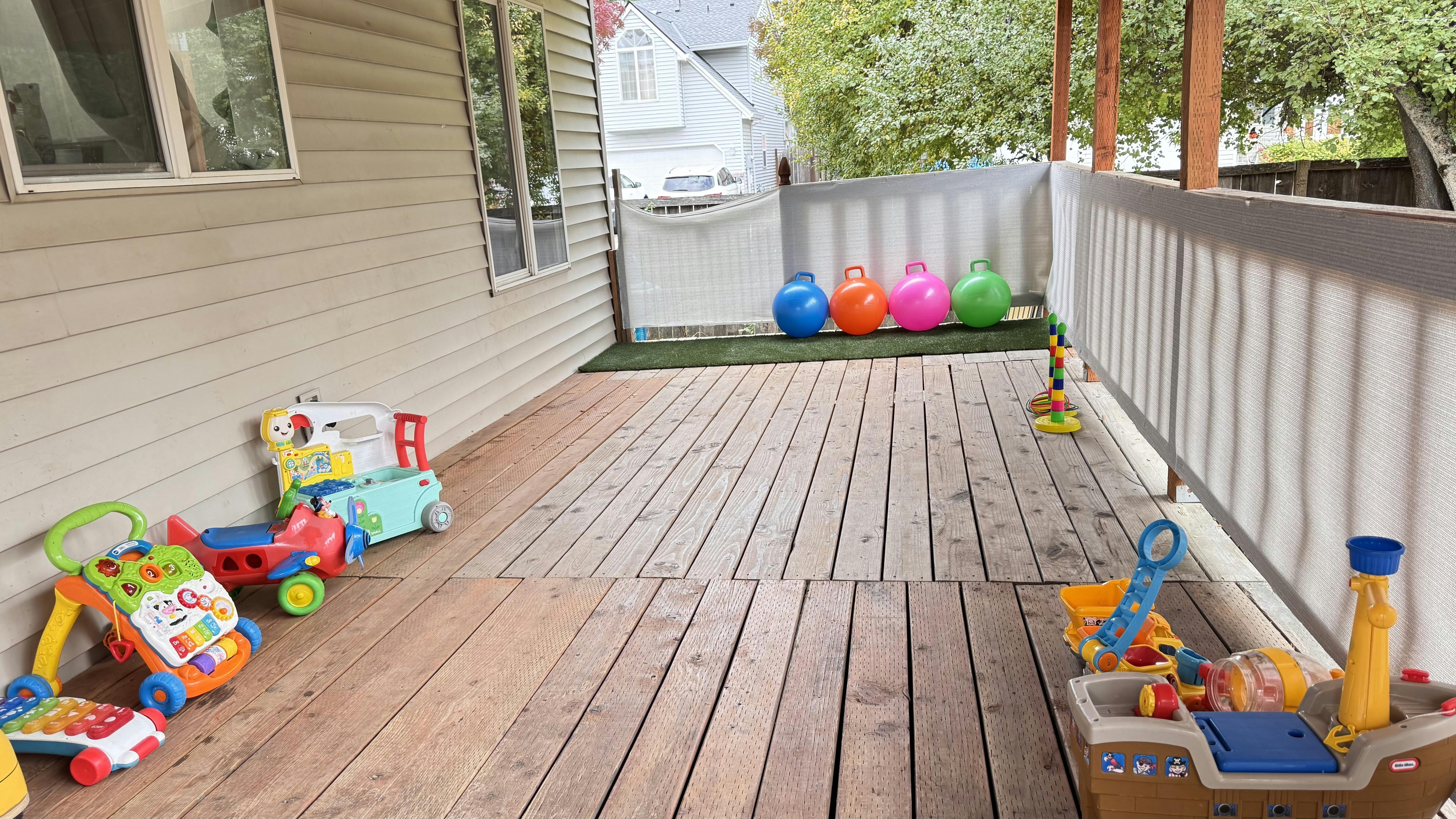 Outdoor deck with children's toys and colorful balls