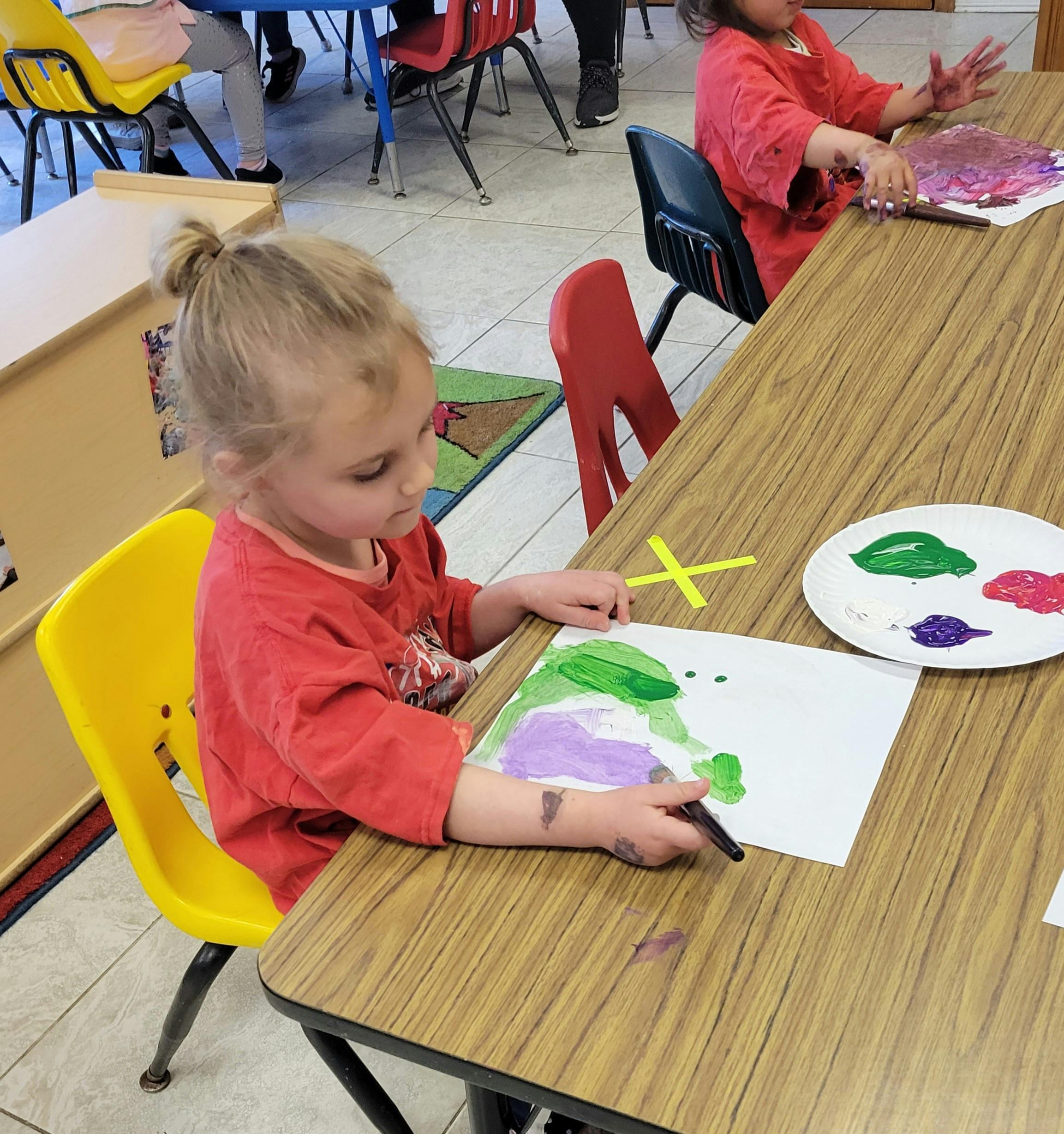 Child painting at a table
