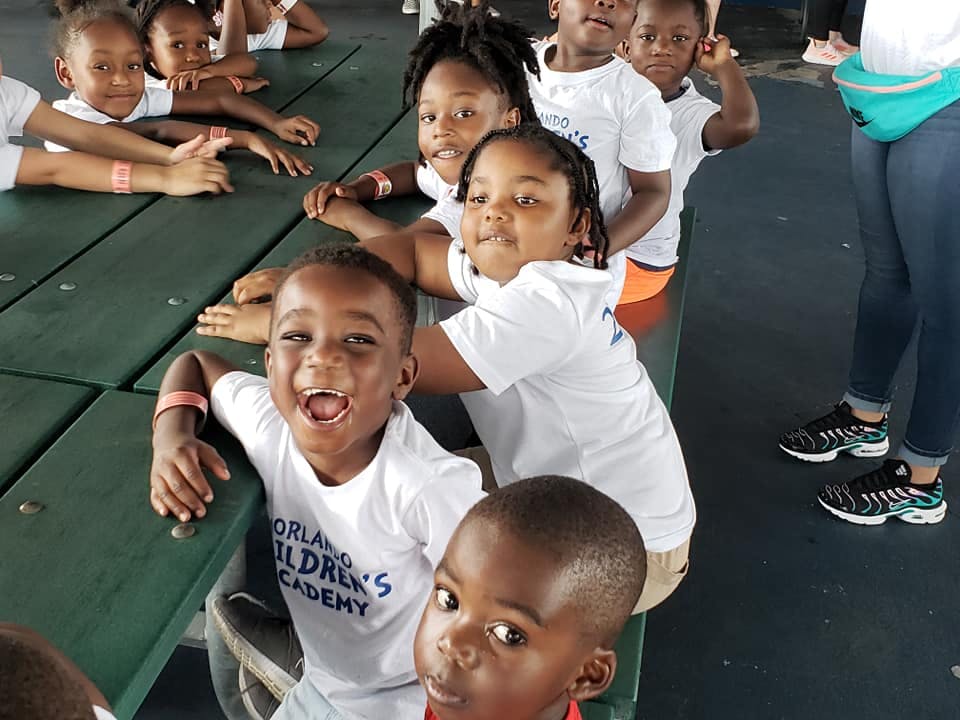 Group of children sitting at a picnic table