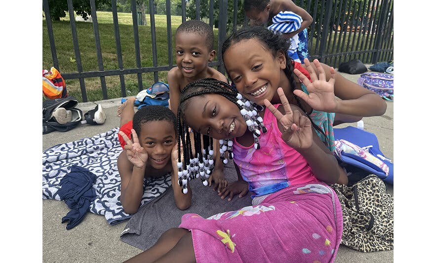 Group of smiling children and teens posing outdoors