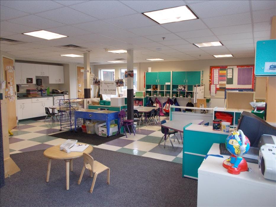 Empty colorful classroom with small tables and chairs