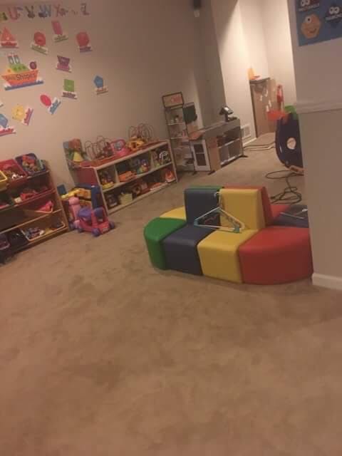 Playroom with colorful block seating and shelves of toys