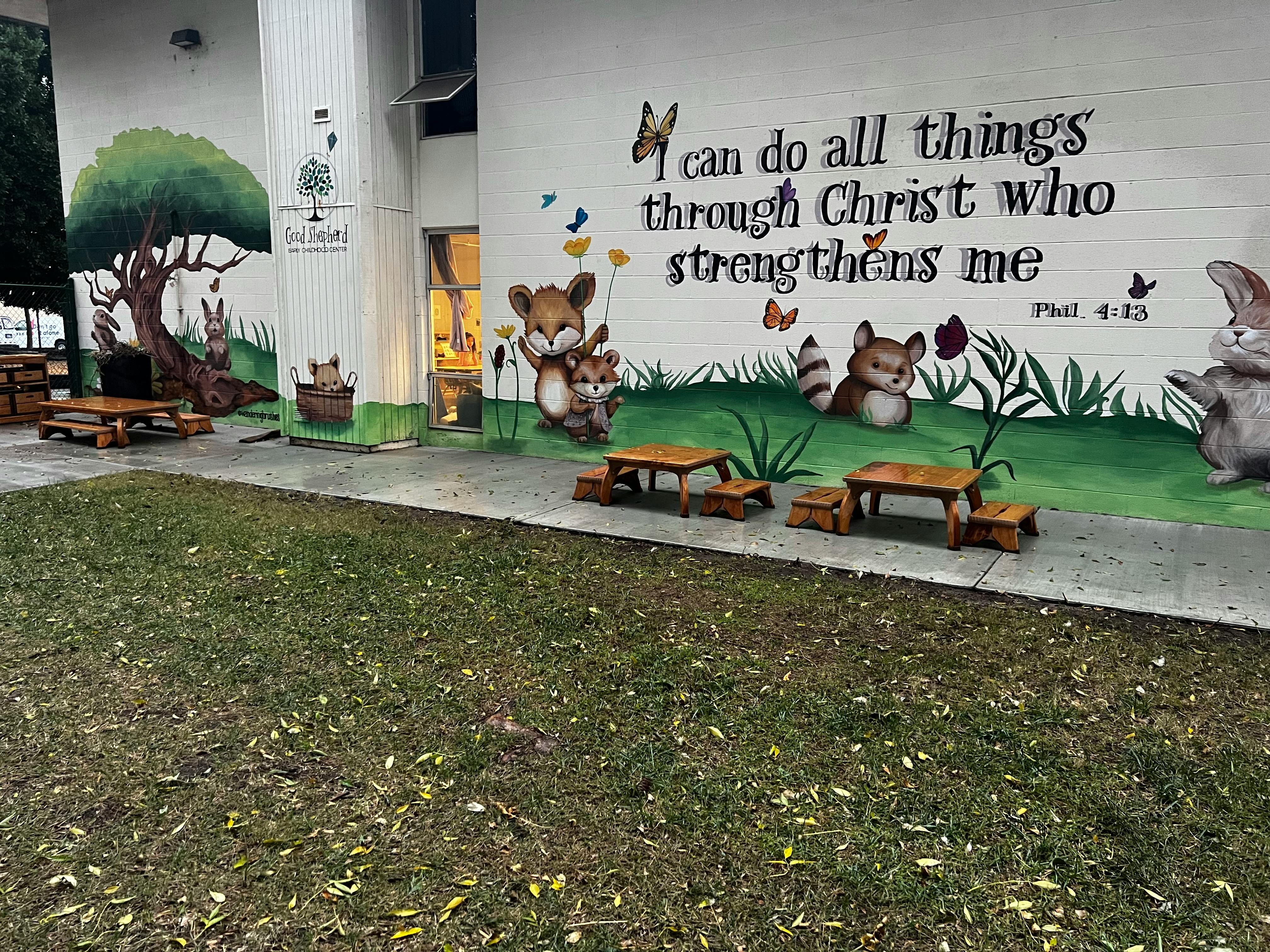 Wall mural with cartoon animals, trees, and text "I can do all things through Christ"