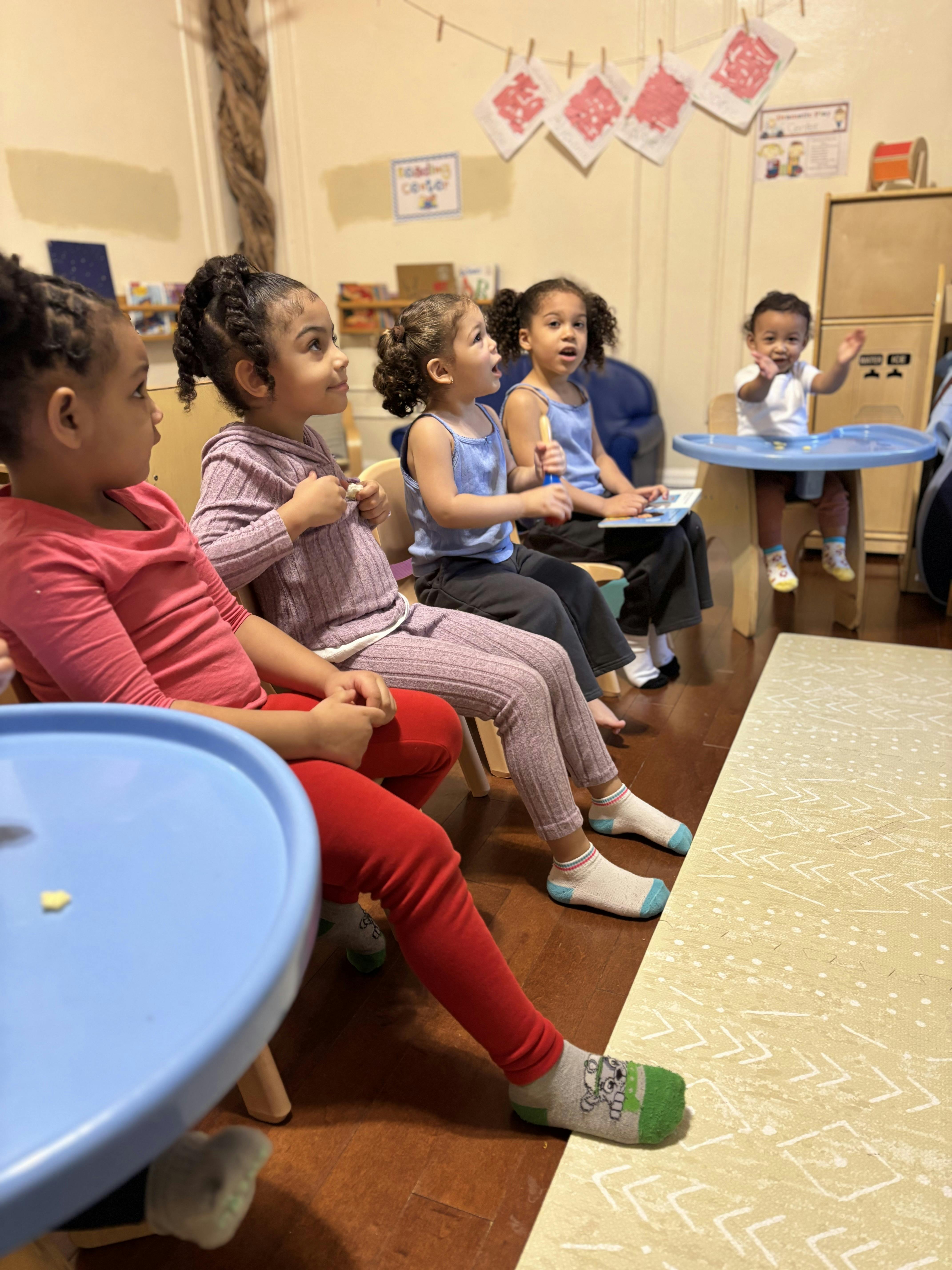 Children sitting and looking forward in a room