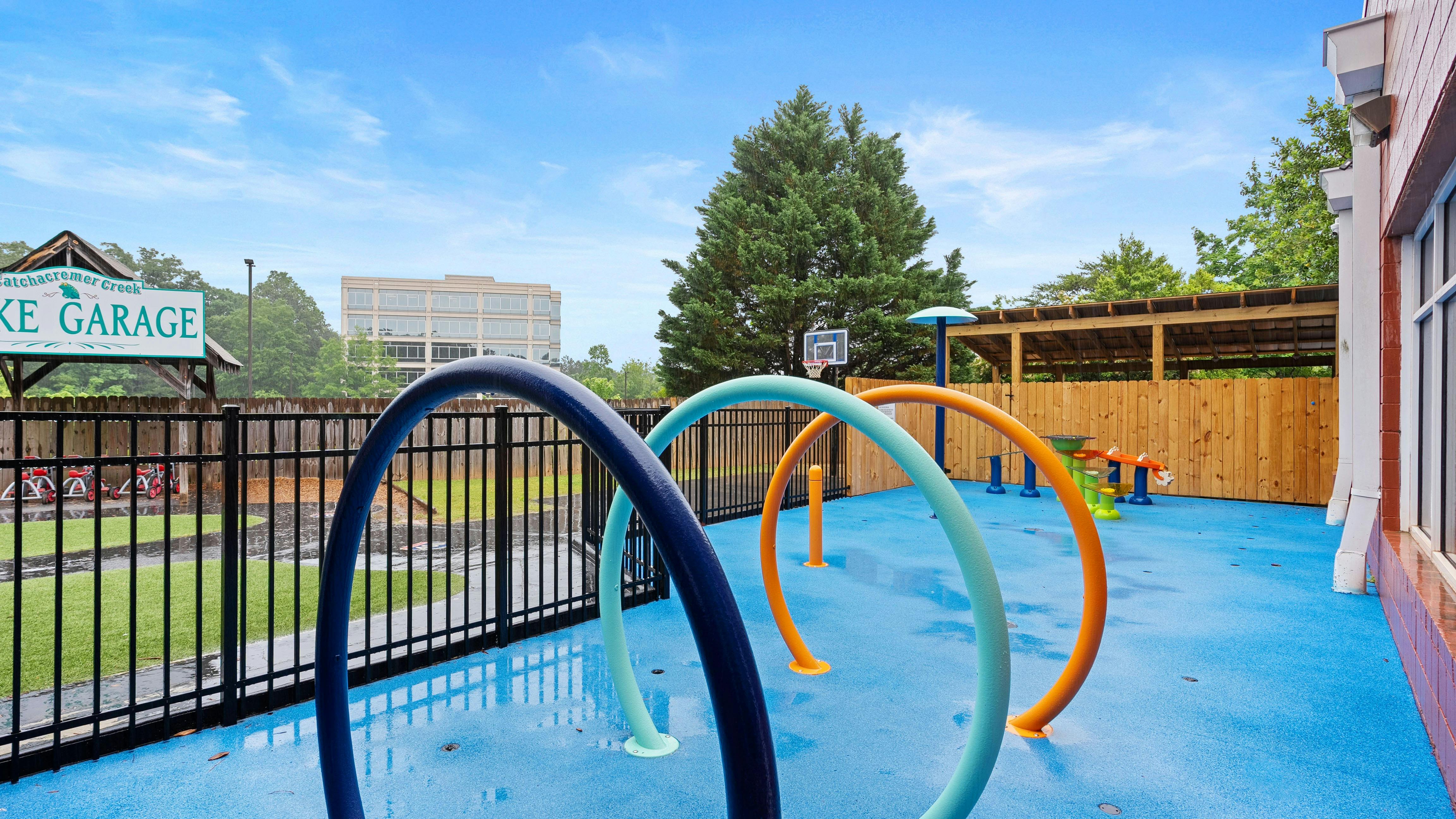 A splash pad with colorful arches on a blue surface