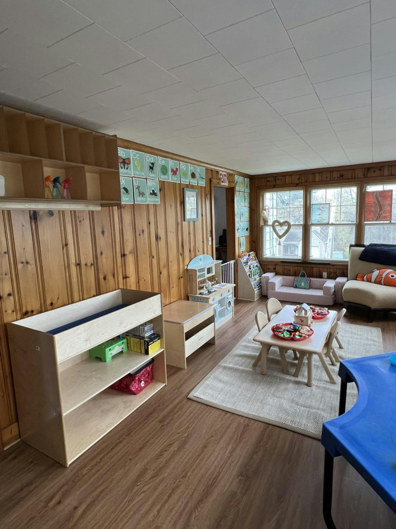 Playroom with small table and chairs, toy kitchen, and shelves