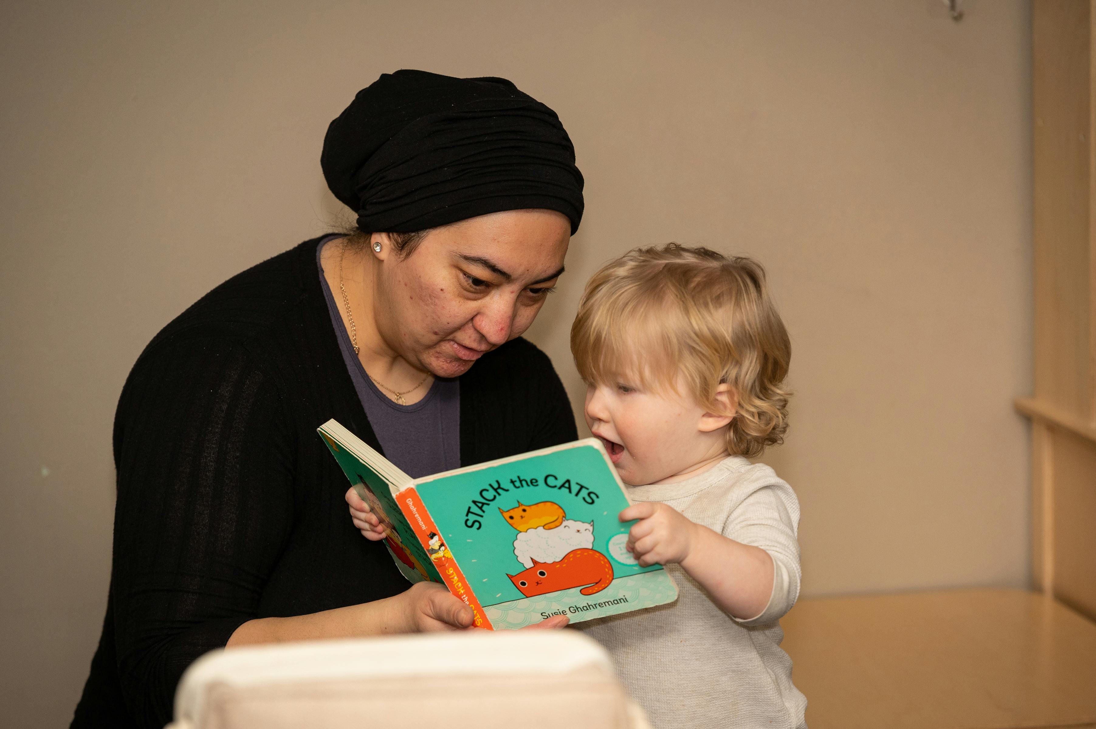 Person reading a book to a child