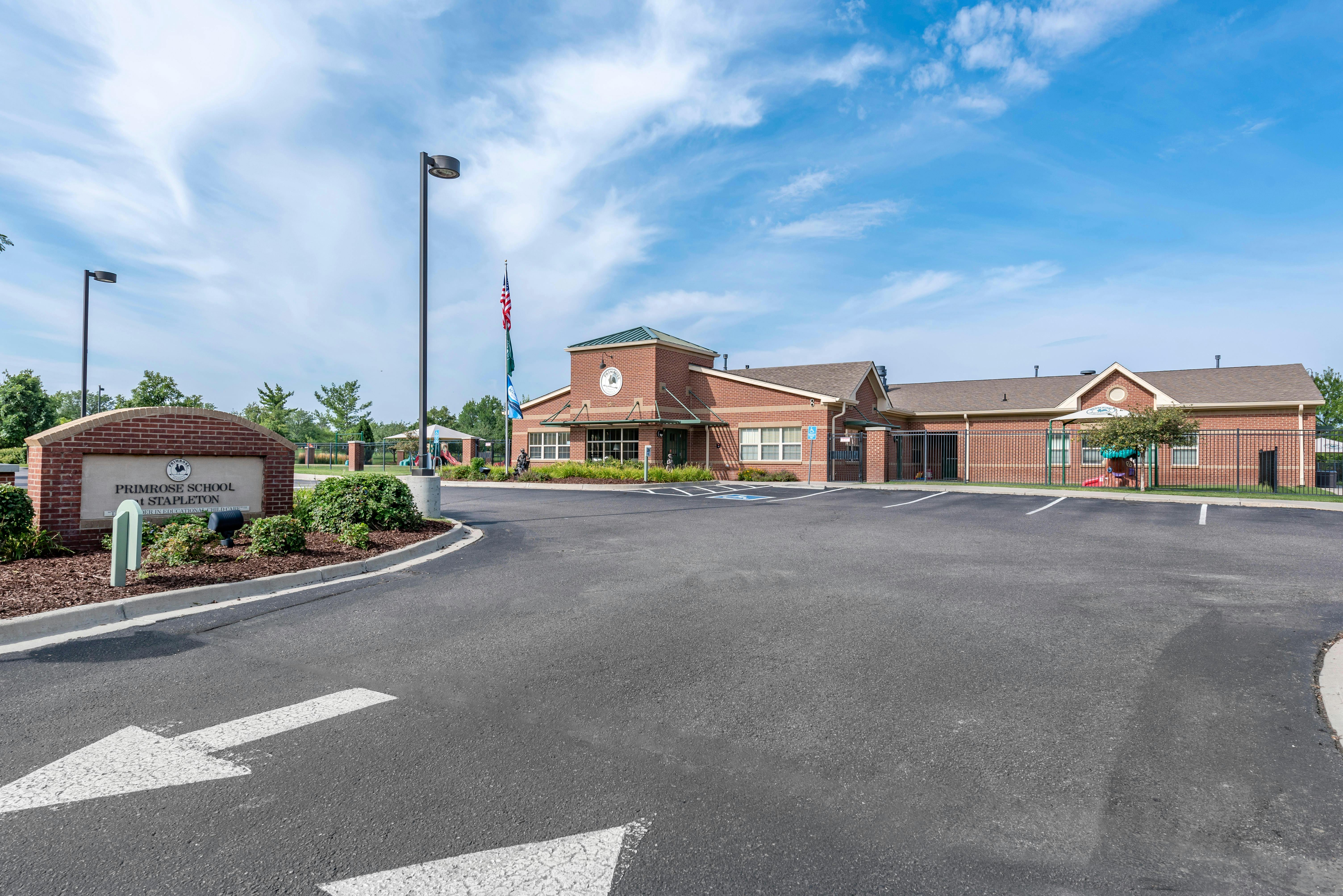 Brick building with a sign and parking lot