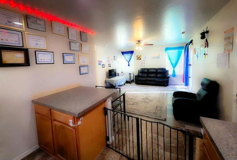 Living room with furniture and framed certificates hanging on the wall