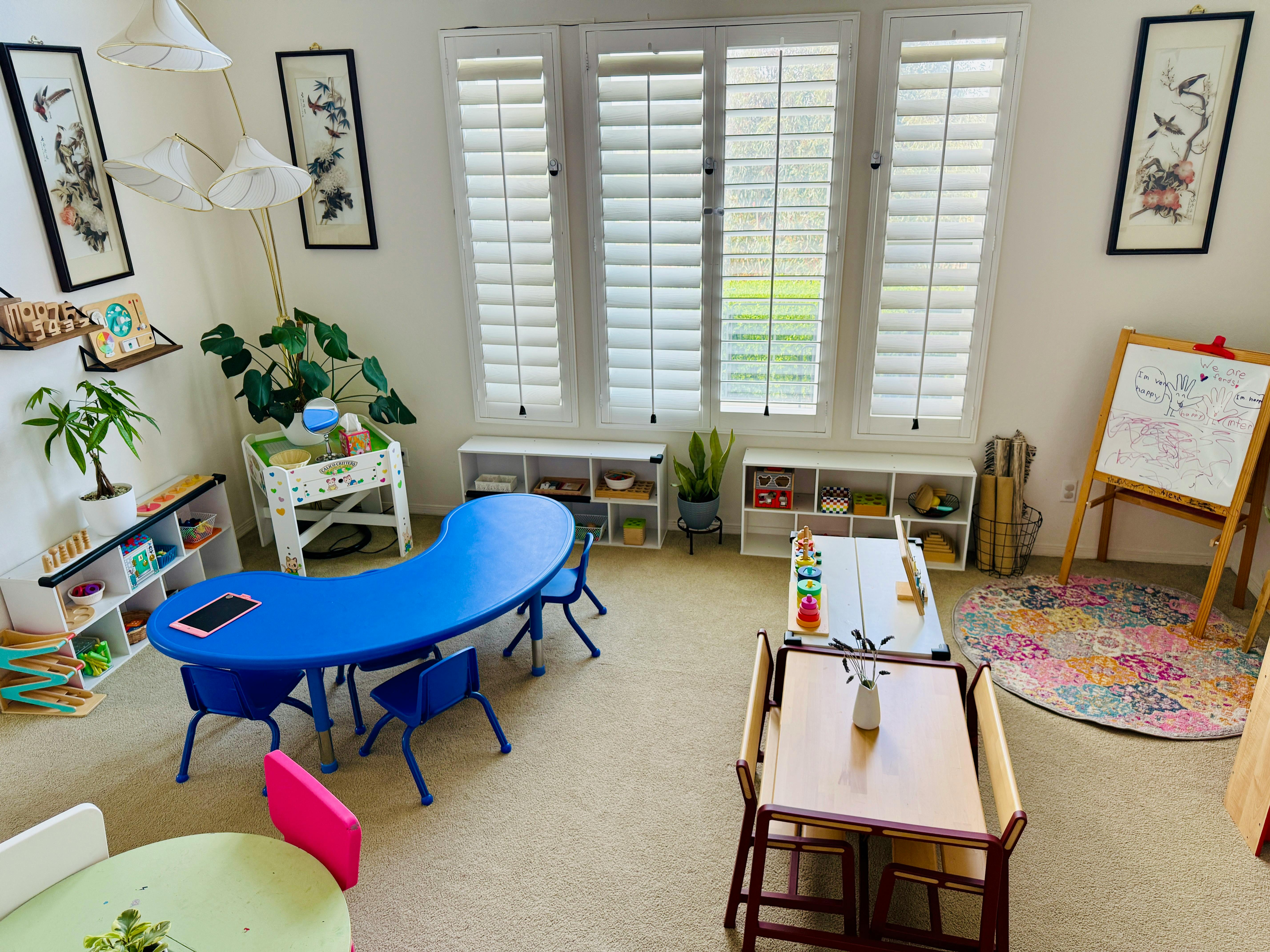 Classroom with blue and wooden tables and chairs