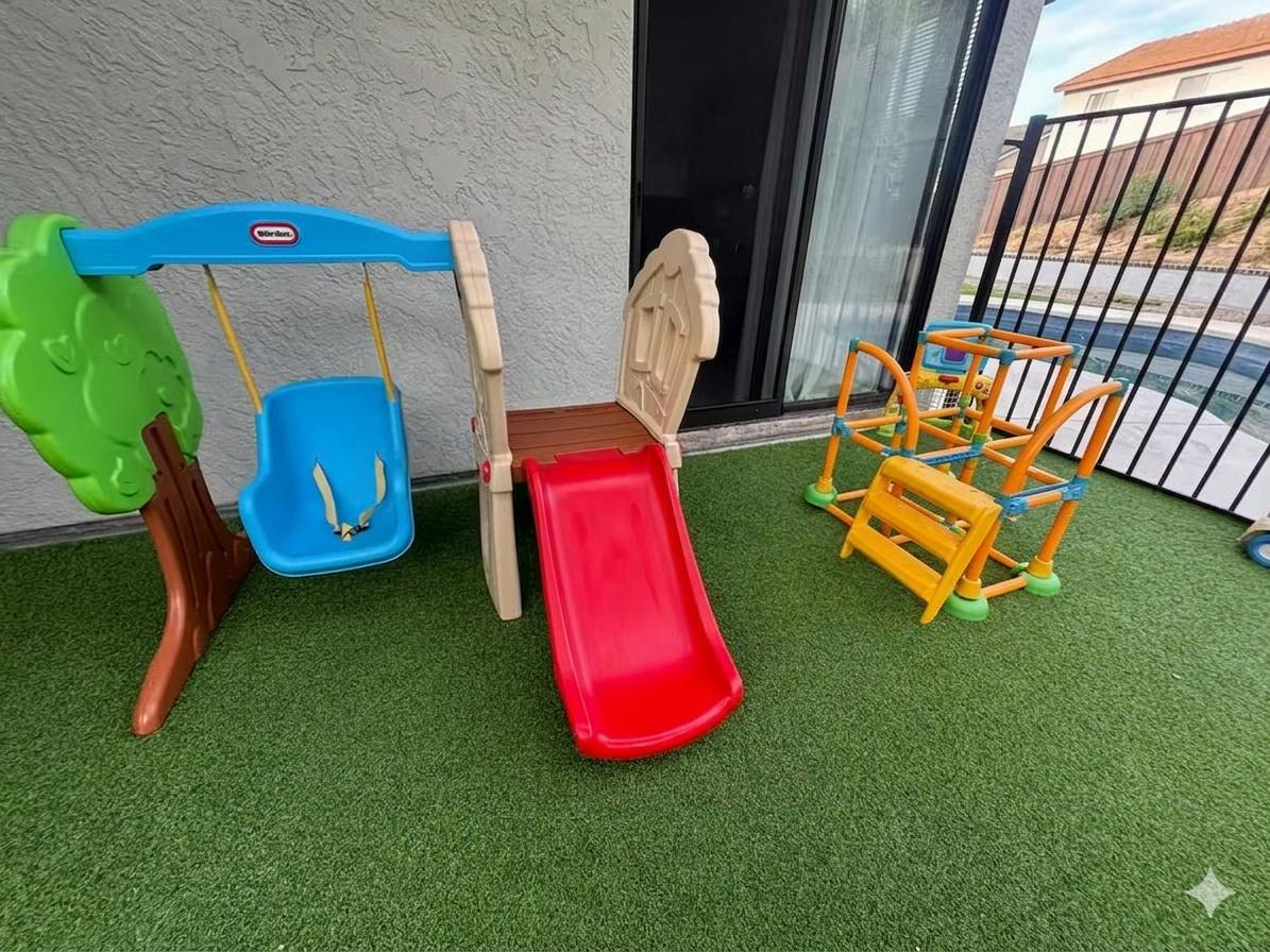 Plastic toy swing set and slide on artificial grass