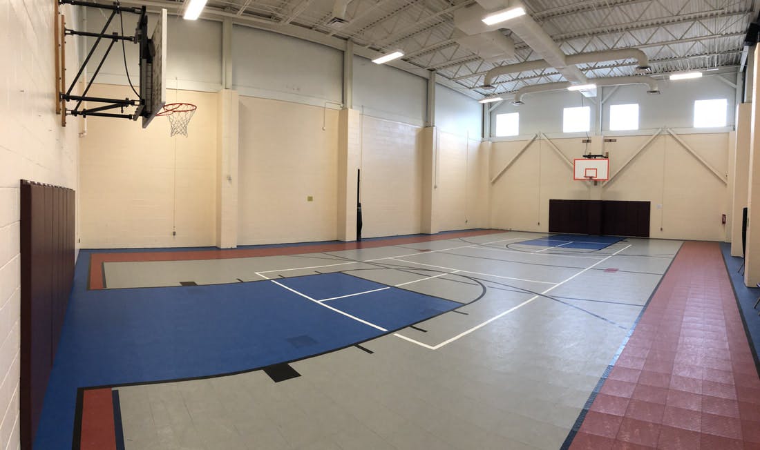 Empty indoor basketball court with two hoops