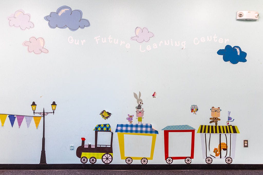 Wall mural with a train, animals, and clouds