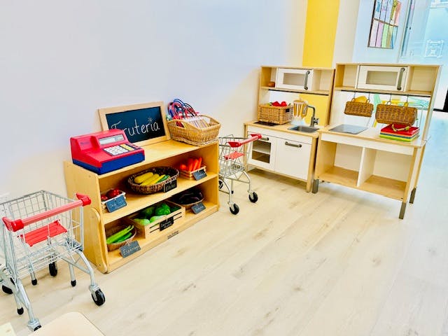 Play kitchen and market stand with toy food and shopping carts
