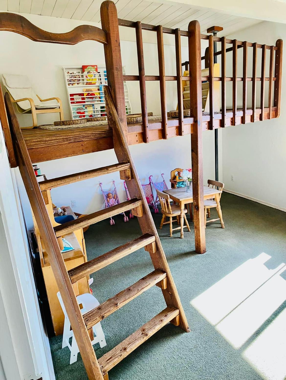 Wooden loft bed with a ladder in a room
