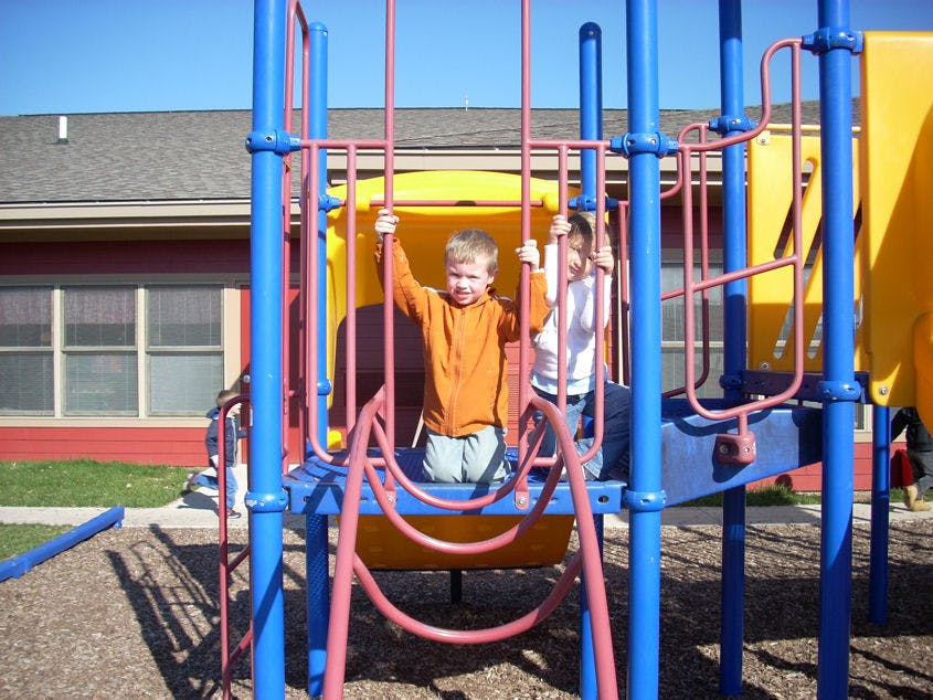 Two children on a playground structure