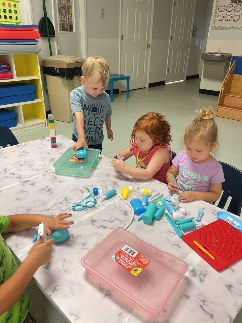 Children playing with toys at a table