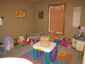 Playroom with toys and a small table and chairs