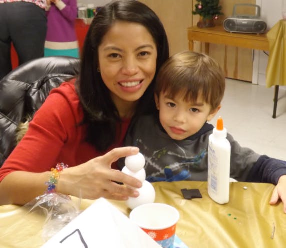 Person and child at a table with craft supplies