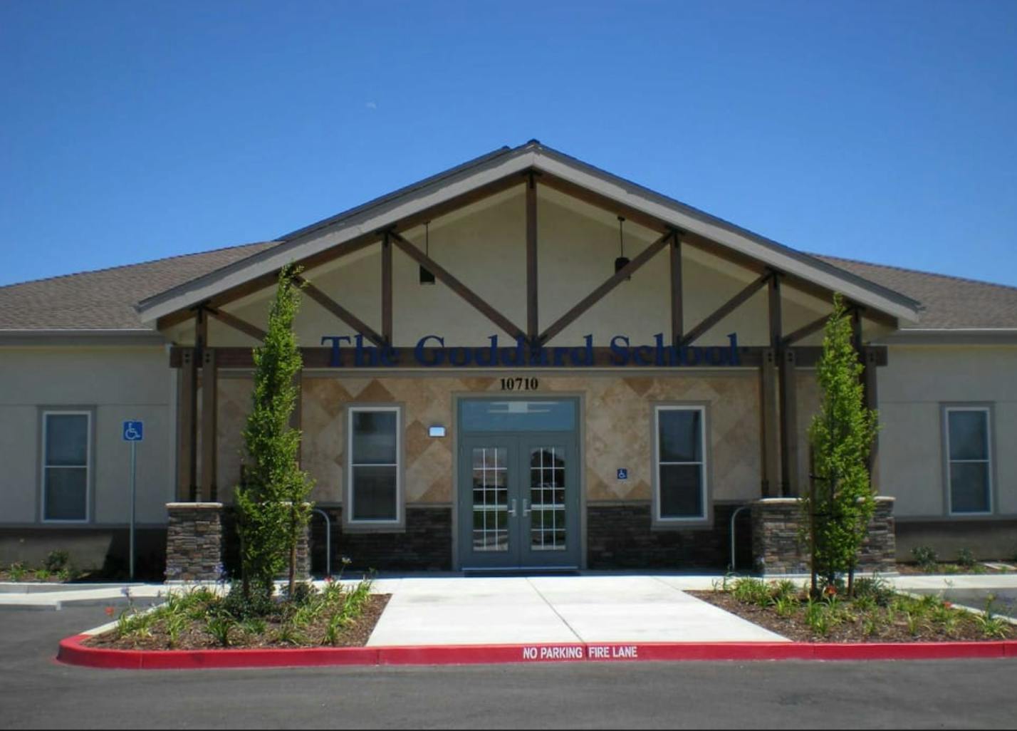 Front exterior of a building with a gabled entrance and double doors