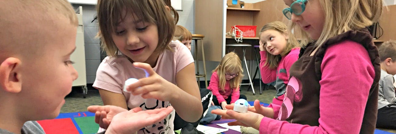 Children playing with small white objects