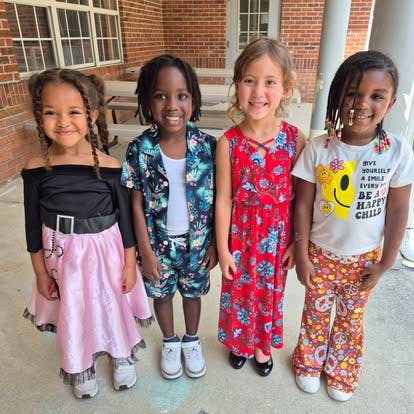 Four children standing and smiling