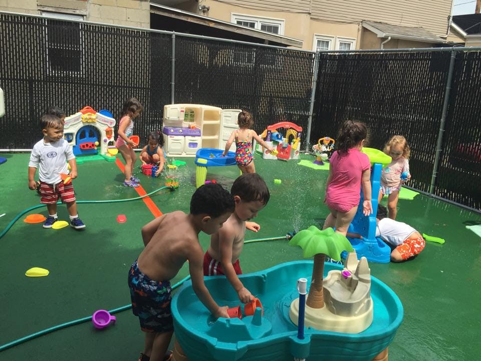 Children playing with water toys in an outdoor area