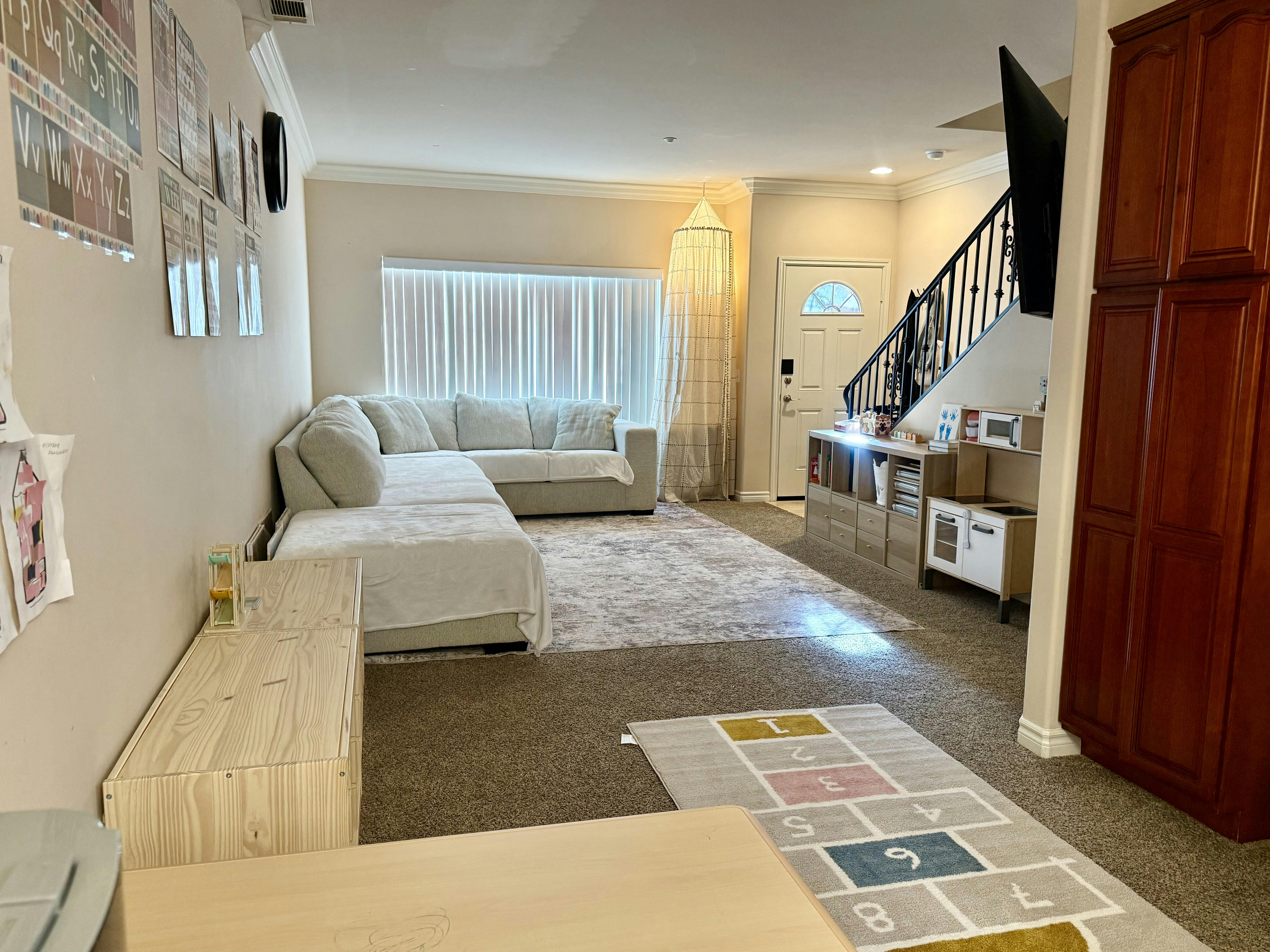 Living room with sectional sofa and child play area