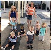 Two adults and multiple children posing outdoors