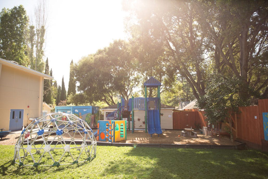 Playground with a geodesic dome climber and play structure with slides