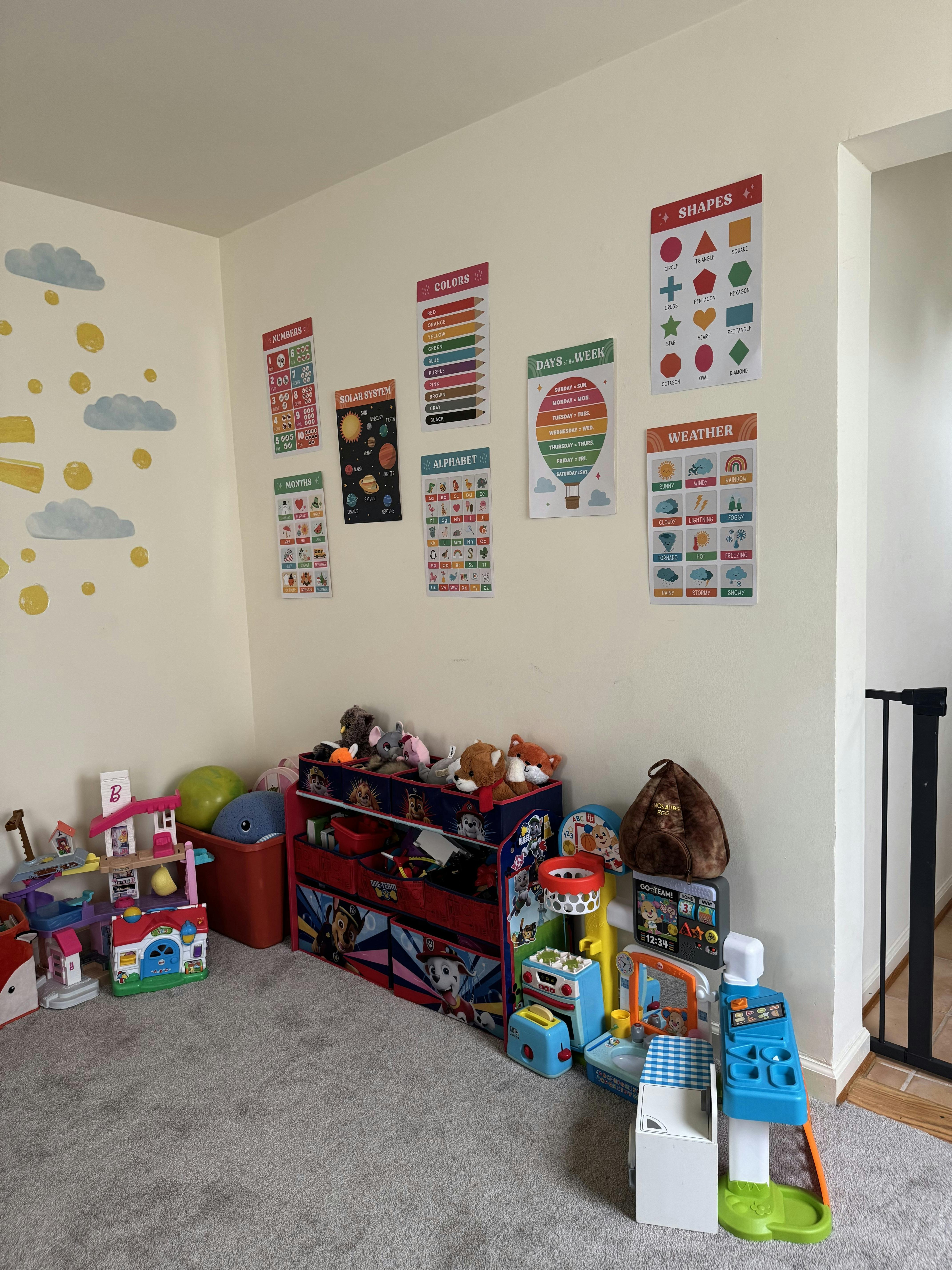 Playroom with educational posters on the wall and toys on the floor