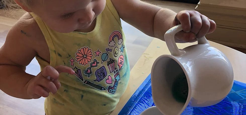 Child pouring from a pitcher