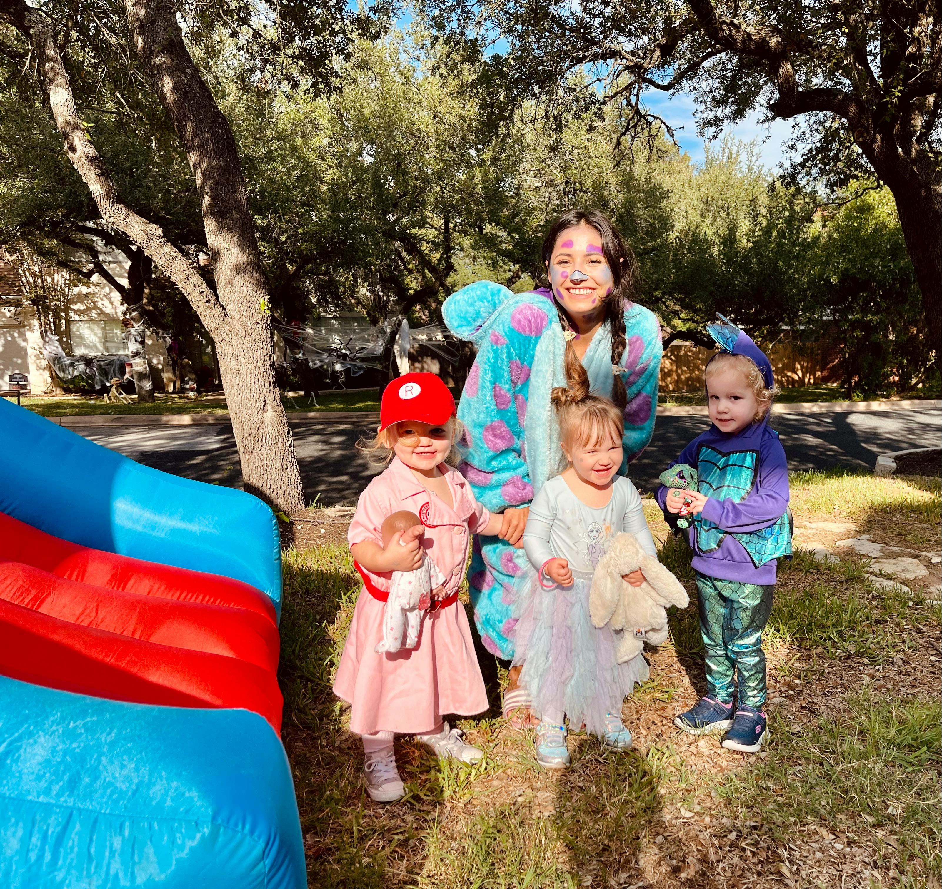 Person and three children standing outdoors