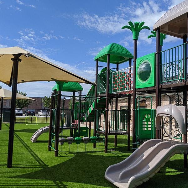 Playground with green turf and play structures