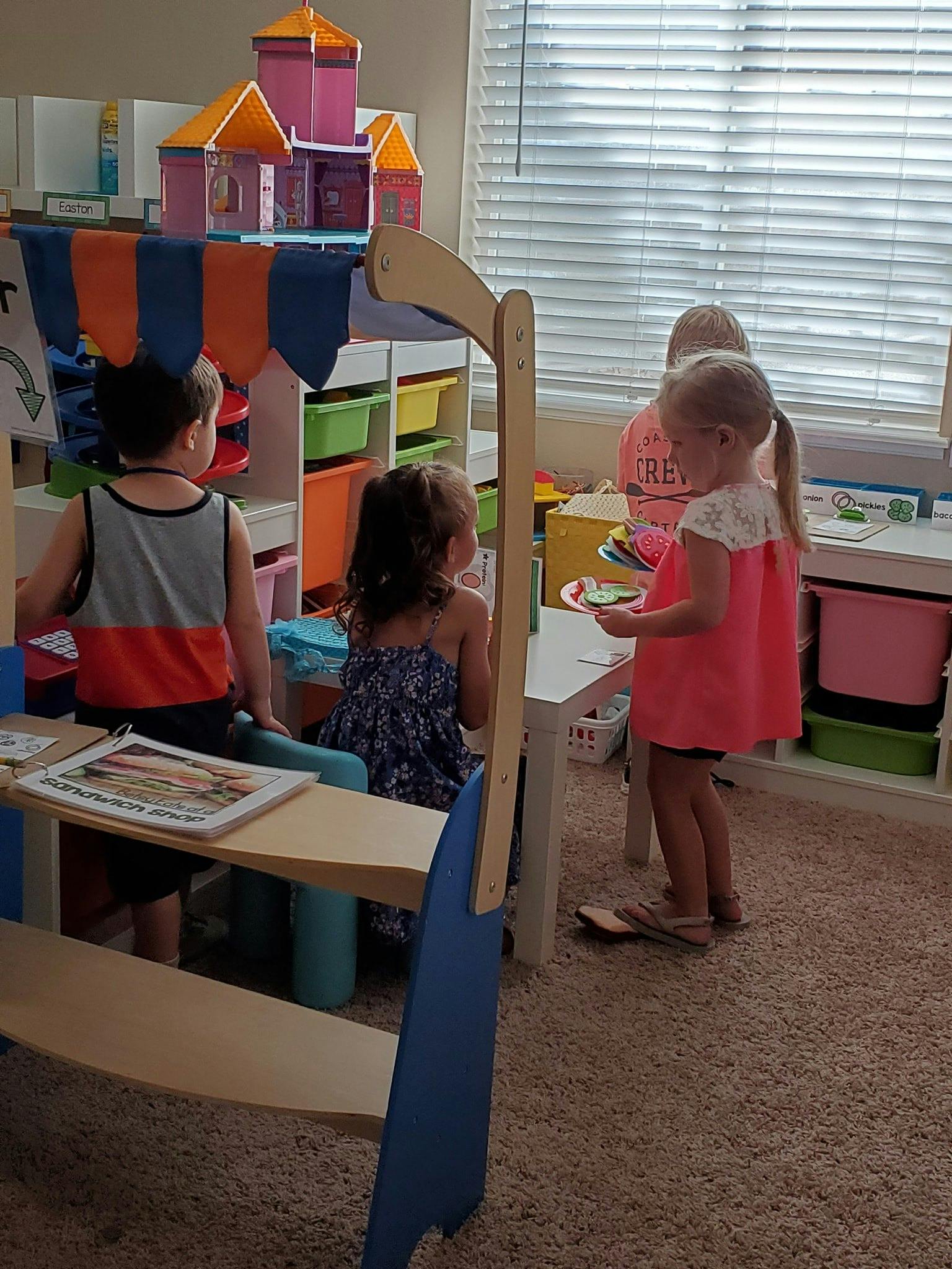 Three children playing in a room with toys