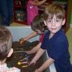 Children playing in a sand table