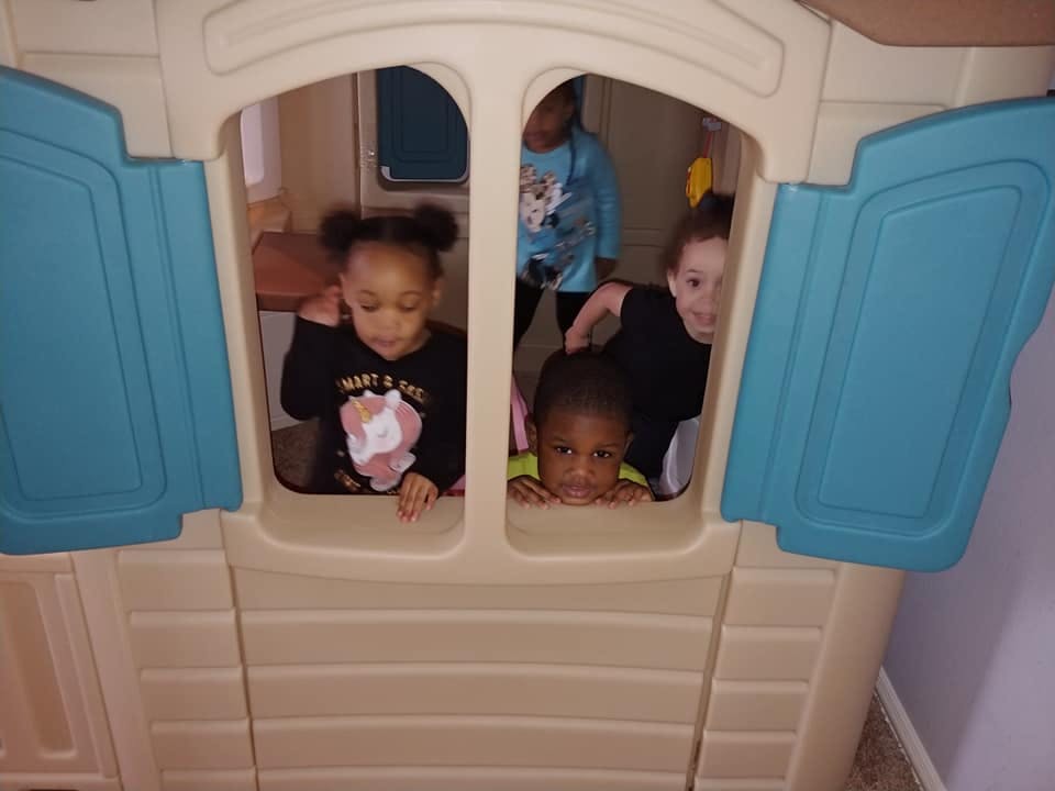 Children playing inside a playhouse